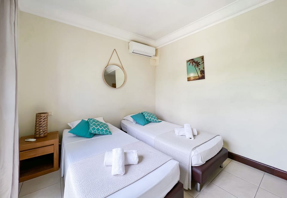 Air-conditioned bedroom with two single beds