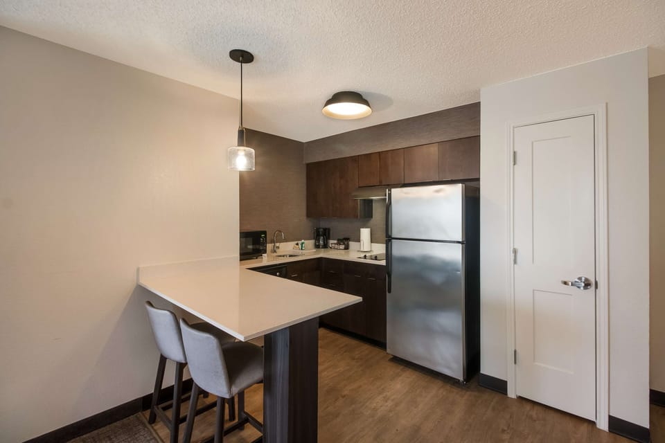 Cook and snack easily with full-size fridge and breakfast bar.