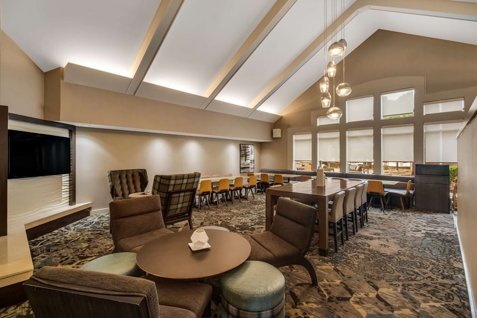 Unwind together in stylish comfort beneath warm, modern lighting.