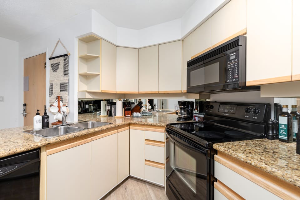 Kitchen- Fully stocked with essential appliances including dishwasher, oven, microwave and coffee maker