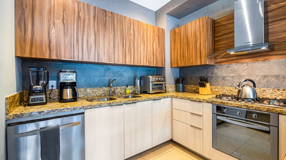 The kitchen is equipped with dishwasher, stove and oven