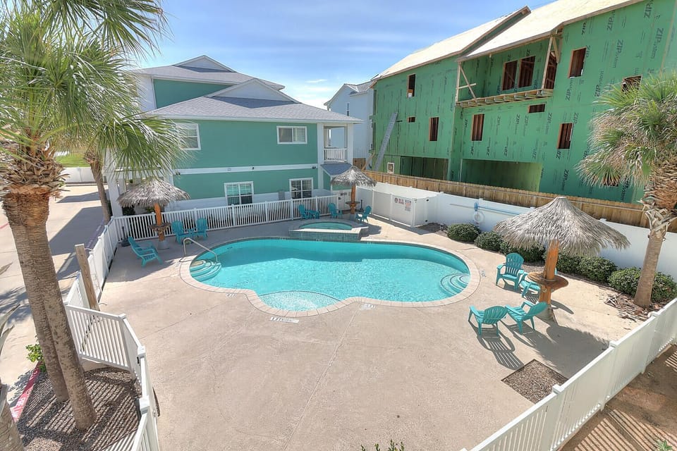 View of pool from second story! - Beautiful overhead view highlighting the community’s pool, hot tub, and surrounding relaxation spaces.