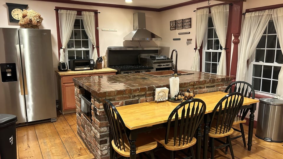 Great kitchen! Brick island. Copper sink. 6-burner gas stove. 2 gas ovens.