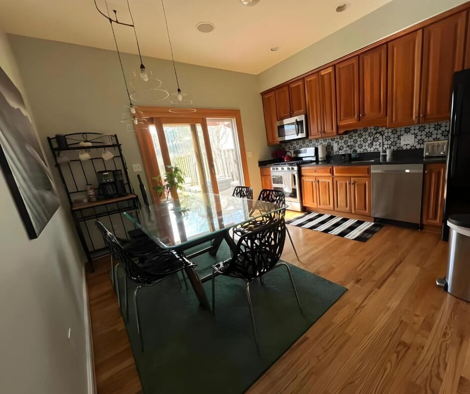 "Enjoy meals in this bright, modern kitchen with a glass dining table and sliding doors leading to the backyard.