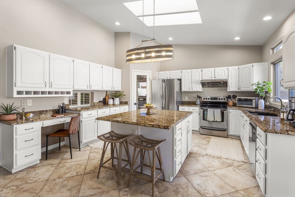 Large kitchen with island and desk to comfortably cook for 10 people