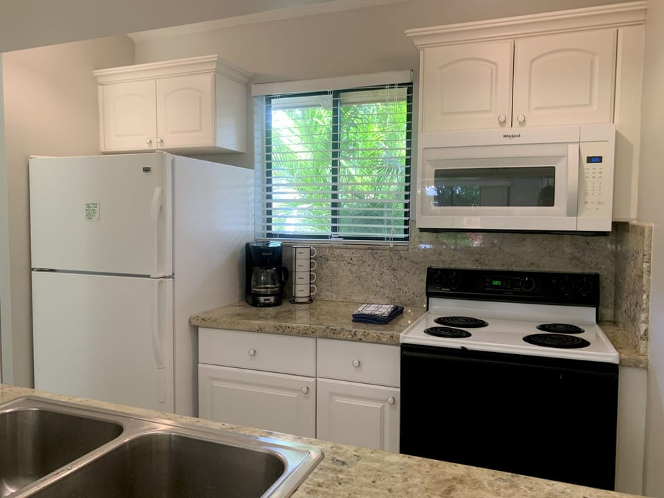 Fully Equipped Kitchen with Microwave, Coffee Pot, Hot Pot and Oven.  
