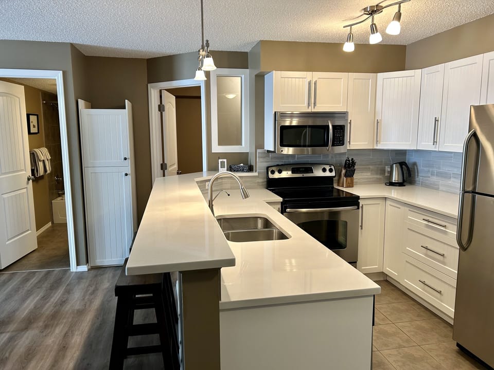 Newly renovated, fully stocked kitchen.
Den (with door) and 2nd bathroom shown