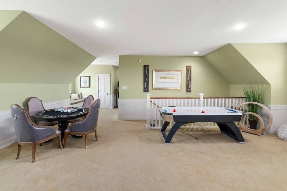 Second floor living area with air hockey, game table, and shuffleboard.