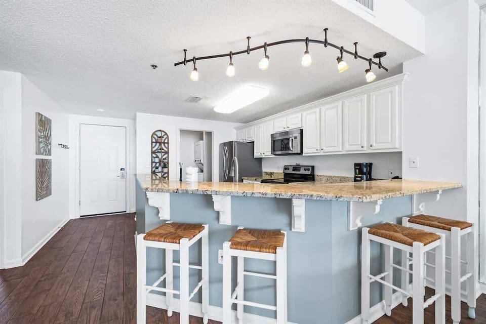 The kitchen island has 4 bar stools for extra seating.
