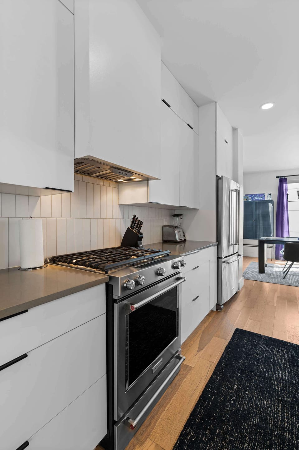 Fully functional kitchen designed with modern white cabinets.
