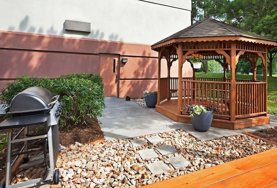 Grill and unwind outdoors beside the charming garden gazebo.