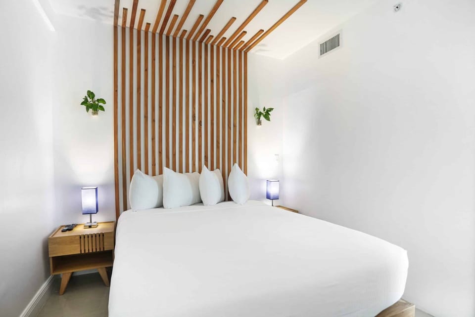 Unwind under crisp linens and soothing designer wood accents.