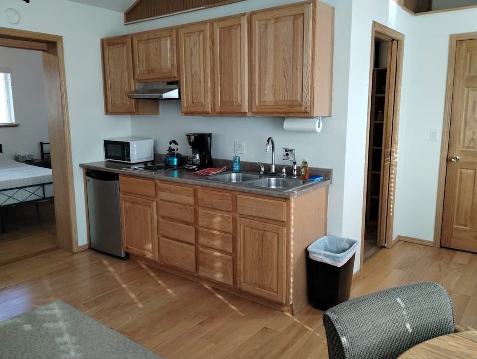 Sky Harbor Cabin Kitchenette – Equipped with Microwave, Toaster, 12-Cup Drip Coffee Maker, Tea Kettle, Coffee, Creamer, Sugar, Tea, Filters, and Basic Cooking Essentials.