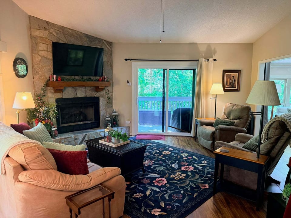 Spacious living area with a cozy fireplace and big TV!