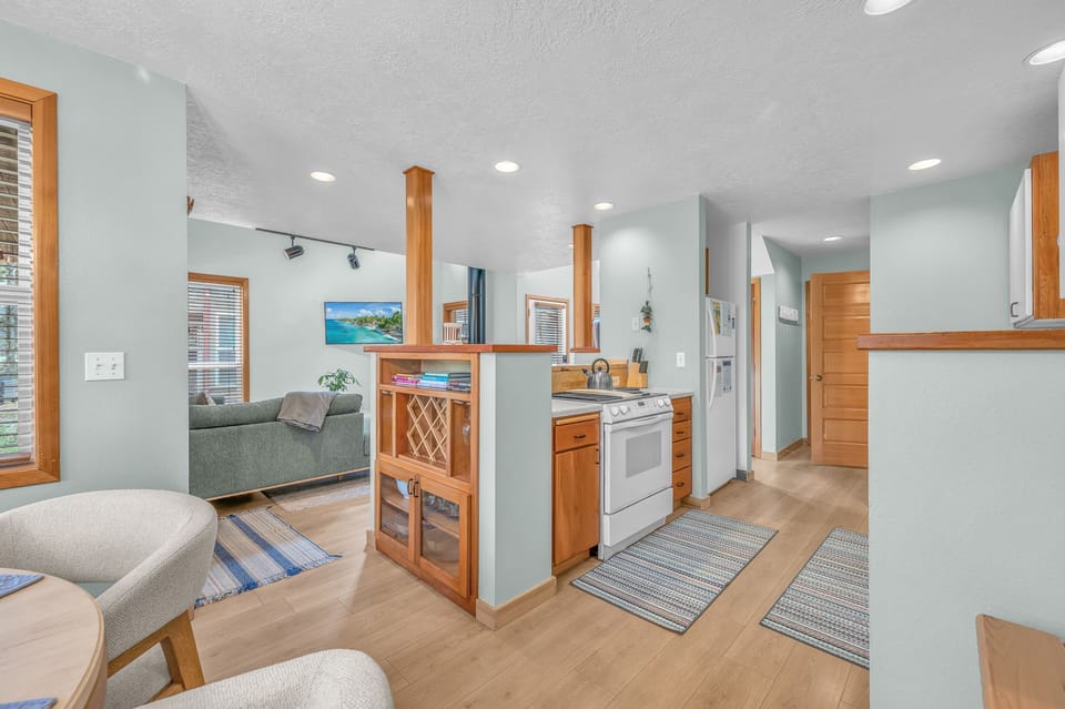 Step into your bright, open-concept retreat where warm wood accents and coastal hues create the perfect blend of comfort and style for your getaway.