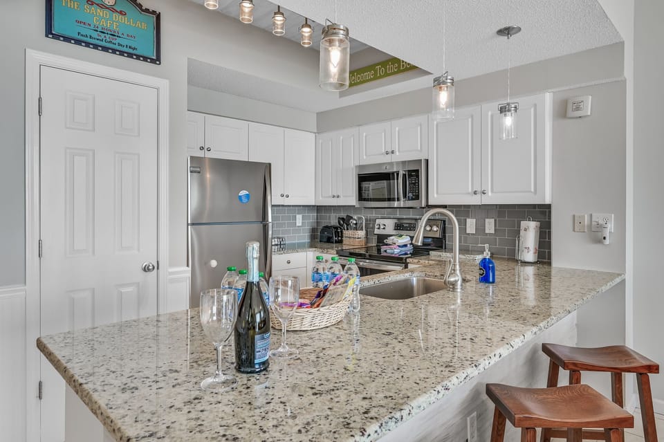 The updated kitchen has granite countertops, stainless steel appliances, and is fully stocked with more than the basics (coffee/tea bar, oils/spices, Tupperware, plenty of pots/pans/cookware)