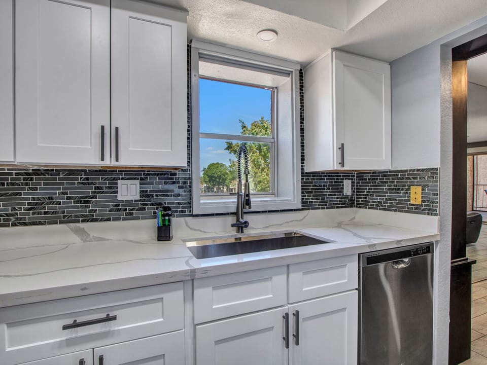 Sink and dishwasher and even a view of the lake