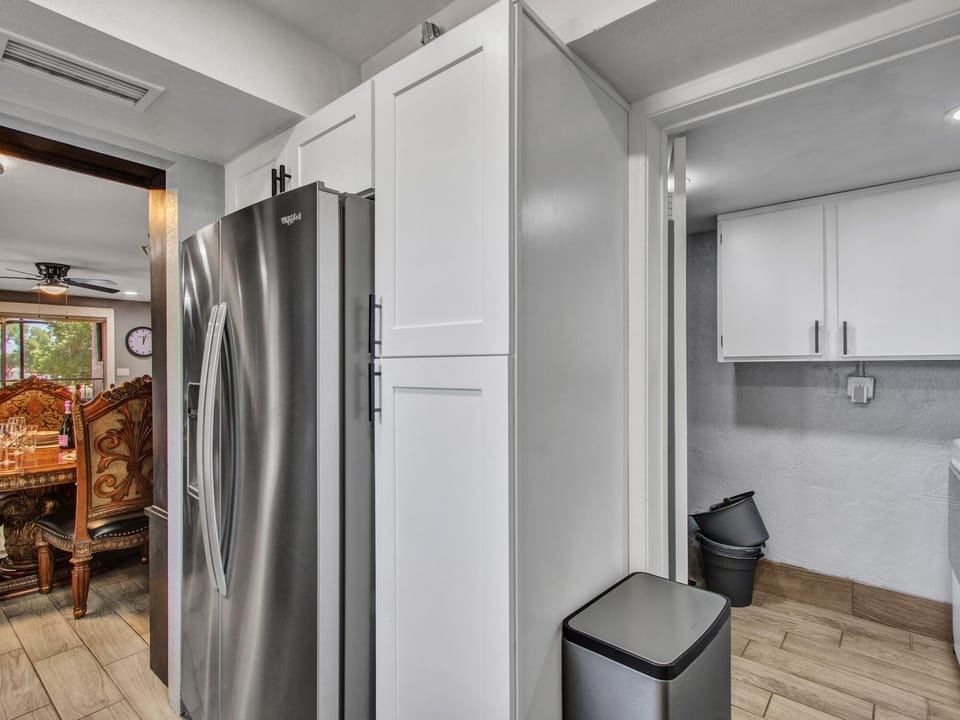 Full size refrigerator with ice and water dispenser. Entrance to laundry.