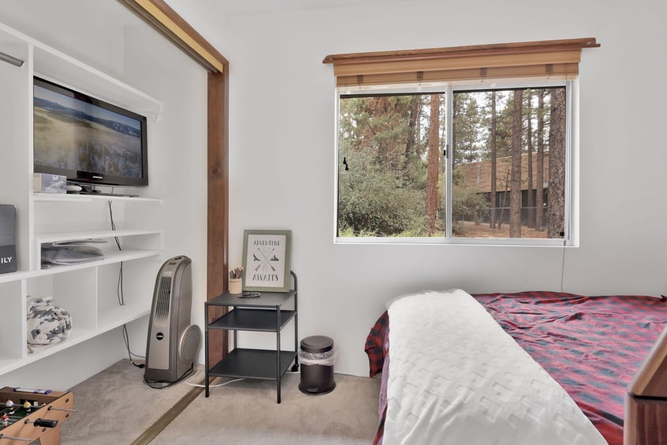 Peaceful cabin bedroom with plush bedding, and beautiful views—ideal for restful nights, cozy mornings, and a relaxing mountain escape.