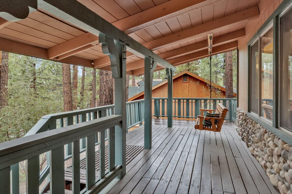 Welcoming cabin entry surrounded by towering pine trees, offering fresh mountain air and a peaceful forest setting—the perfect first impression for your Big Bear Lake getaway.