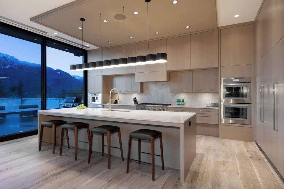 - Contemporary kitchen with a large island and designer lighting  
- High-end appliances and open layout overlooking mountain views  
- Perfect space for cooking and gathering in a stylish setting  
