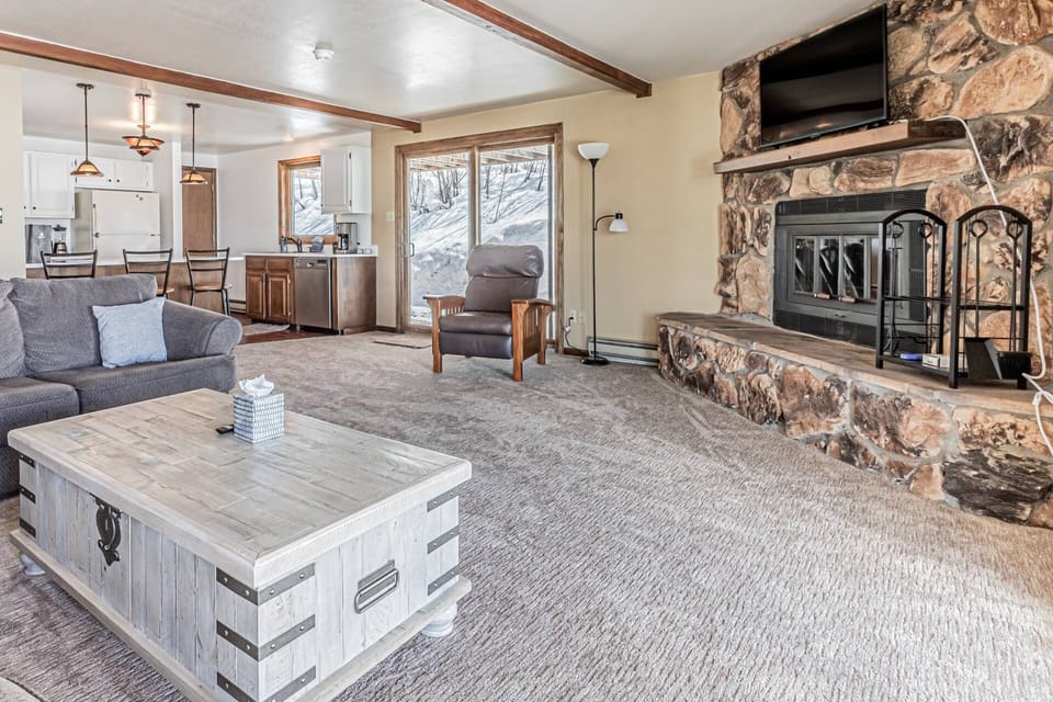 Unwind in the spacious open living area, complete with a warm fireplace and large TV for the perfect night in.