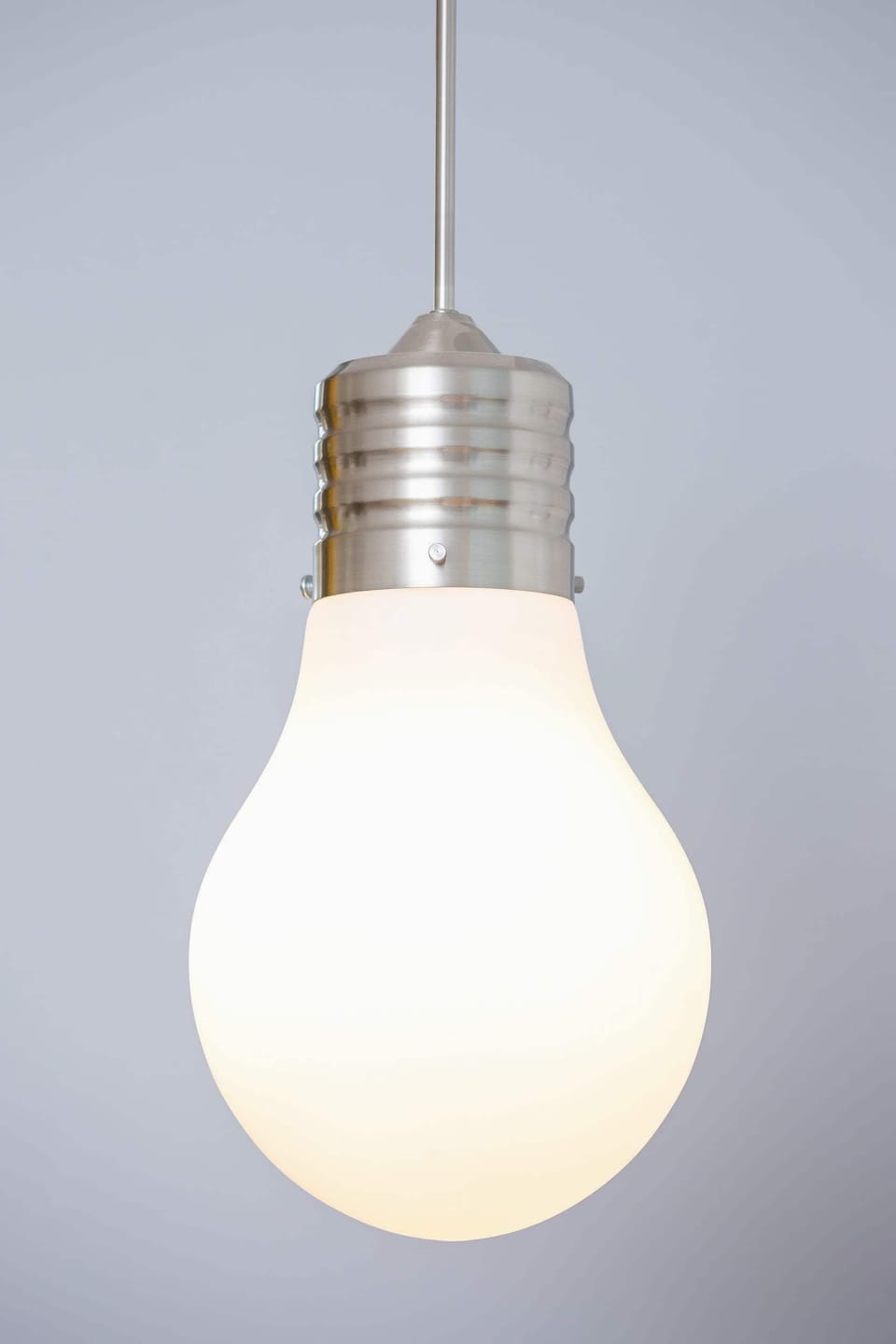 A modern light fixture with an industrial-style bulb, adding a contemporary touch to the decor.
