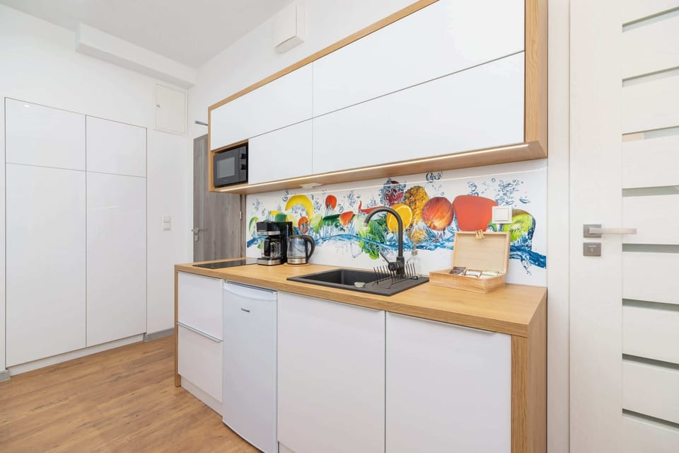 Another view of the kitchen area, showcasing its ample storage and functional design.
