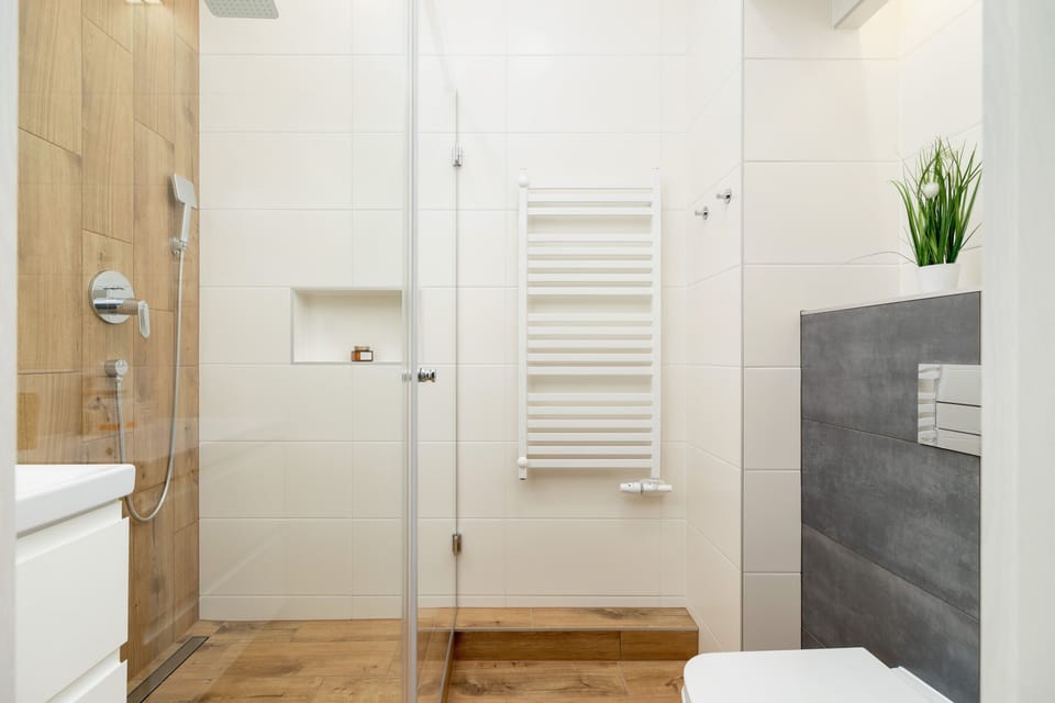 Another view of the bathroom, featuring a sleek sink, mirror, and contemporary fixtures.
