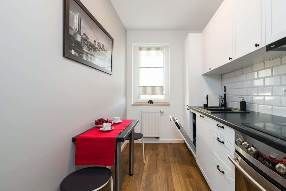 Another view of the kitchen, highlighting its ample storage space and modern appliances.
