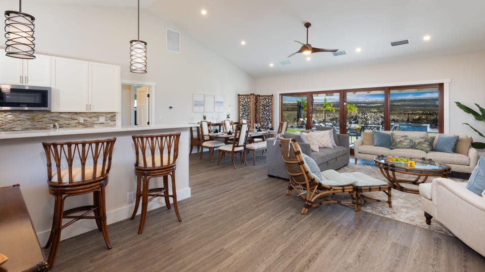 Open concept kitchen and living room with additional island seating