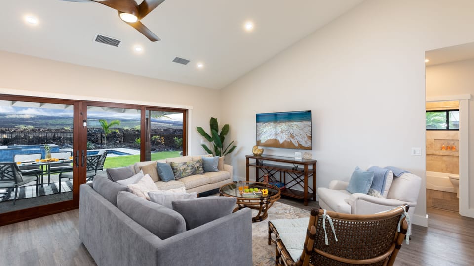 Large living room with Queen Sleeper sofa and new large smart TV.