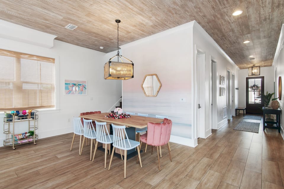 Spacious dining area with seating for 10 and hallway access to bedrooms. This dining room is both inviting and stylish!
