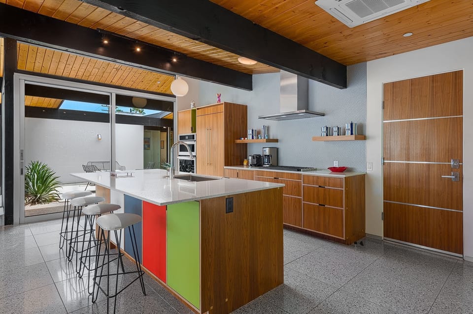 Gather around the stylish kitchen bar with seating for two. Featuring stainless steel appliances, sleek countertops, and ample cabinet space, it's the perfect space to cook and gather with family and friends, creating delicious memories together.