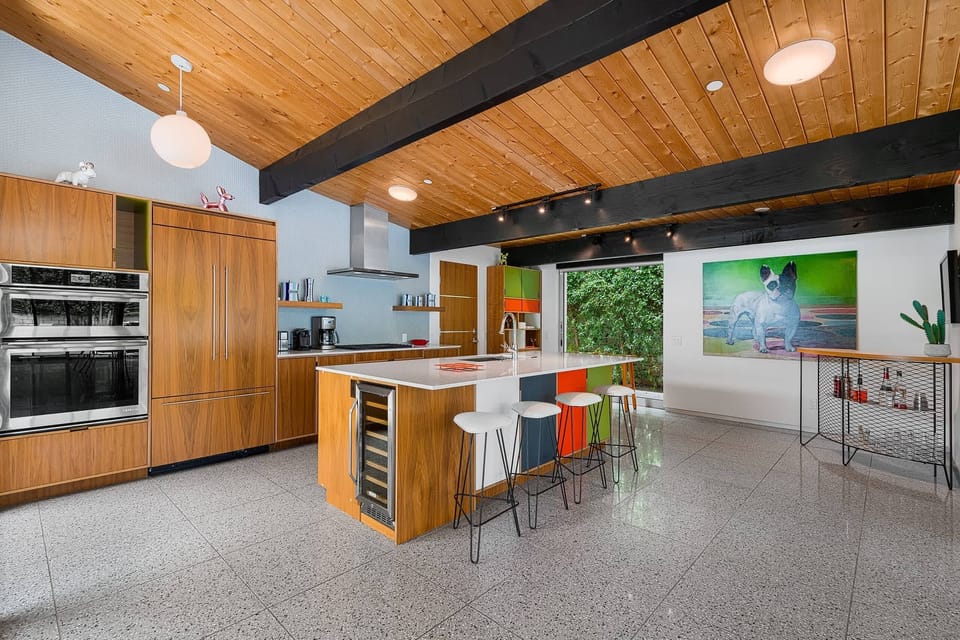 Gather around the stylish kitchen bar with seating for two. Featuring stainless steel appliances, sleek countertops, and ample cabinet space, it's the perfect space to cook and gather with family and friends, creating delicious memories together.