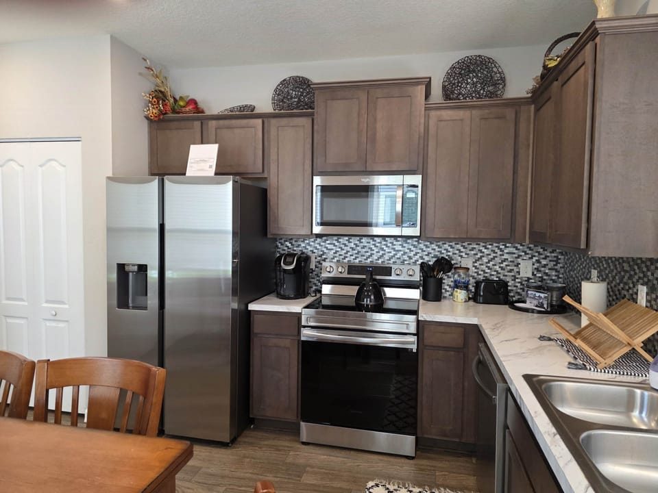 Fully Equipped Kitchen features modern appliances and plenty of counter space.