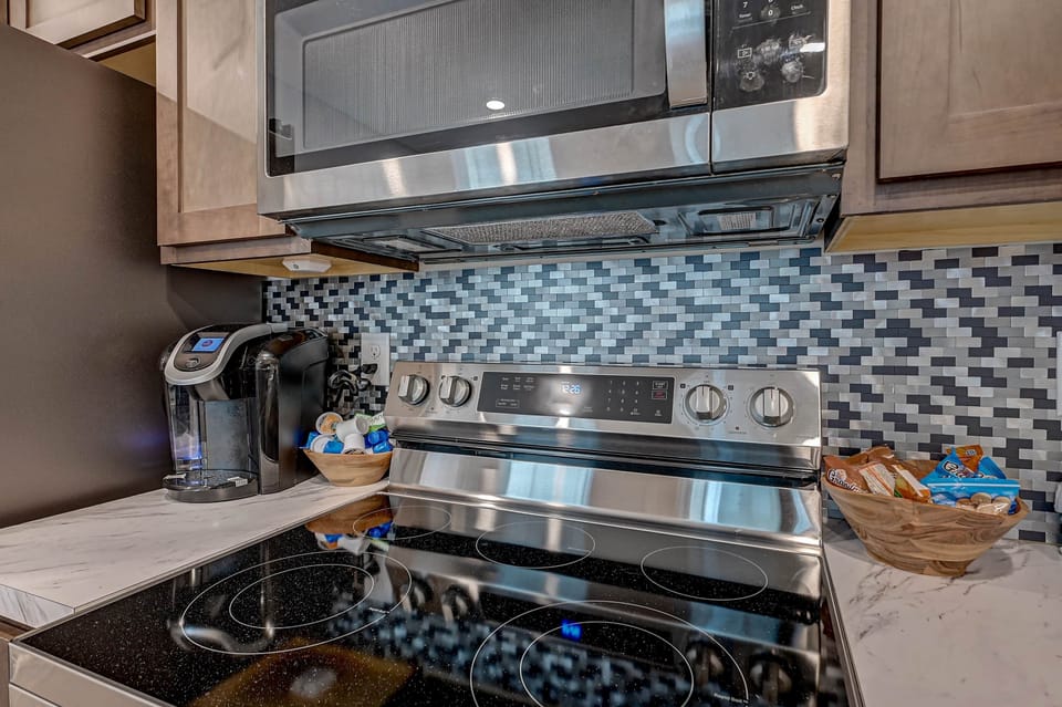 Convenient oven, microwave and coffee maker makes cooking meals easy.