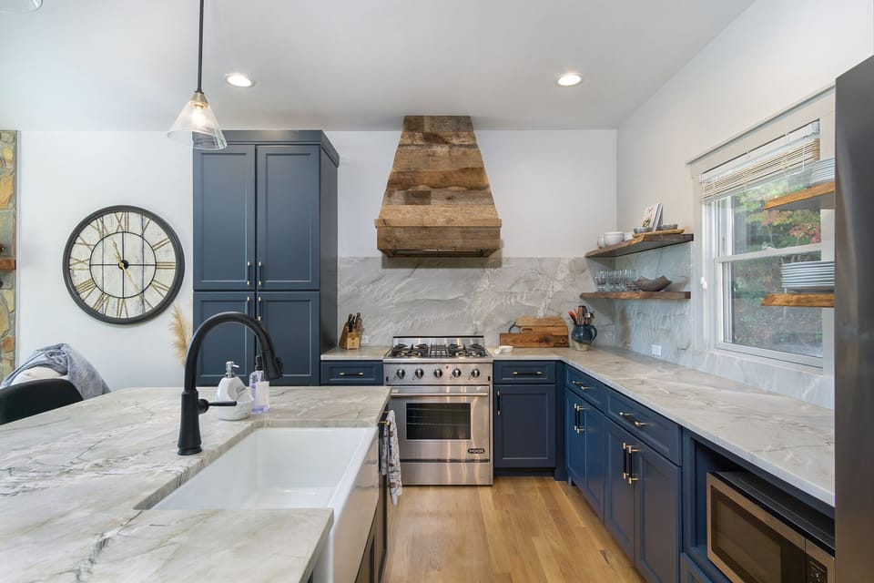 kitchen with gas oven and stove top- barn wood wrapped vent