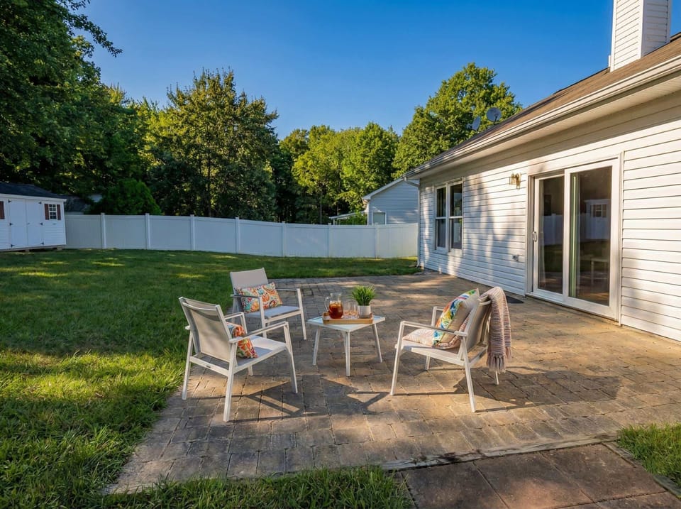 Back patio with outdoor seating and fenced yard.