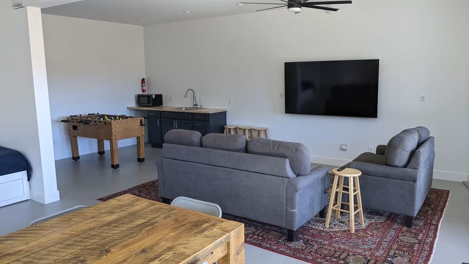 Entertainment Area in Basement with Wet Bar, TV and Foosball Table