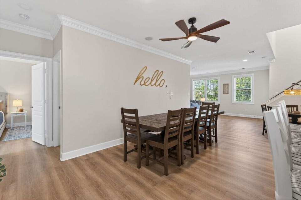 Open-concept dining space with ample seating and easy access to the kitchen and living areas.