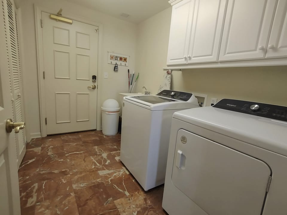Washer and dryer view with rear door in background