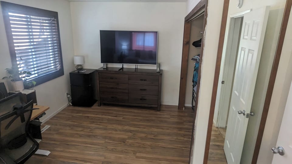 4th bedroom , dresser ,smart tv, & with a roll out single bed , and closet