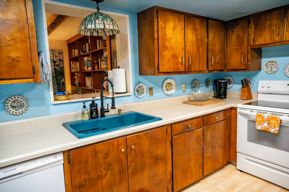 Kitchen with dishwasher, stove, microwave, toaster oven and a coffee station