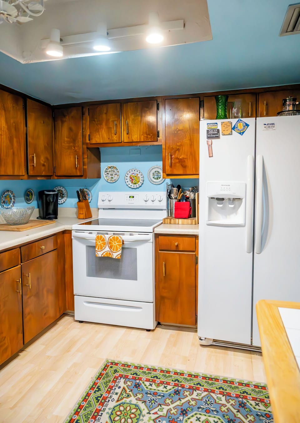 Kitchen with dishwasher, stove, microwave, toaster oven, and a coffee station