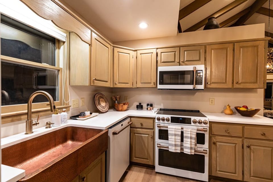 Hosting a family event? This modern kitchen boasts a double oven and microwave.