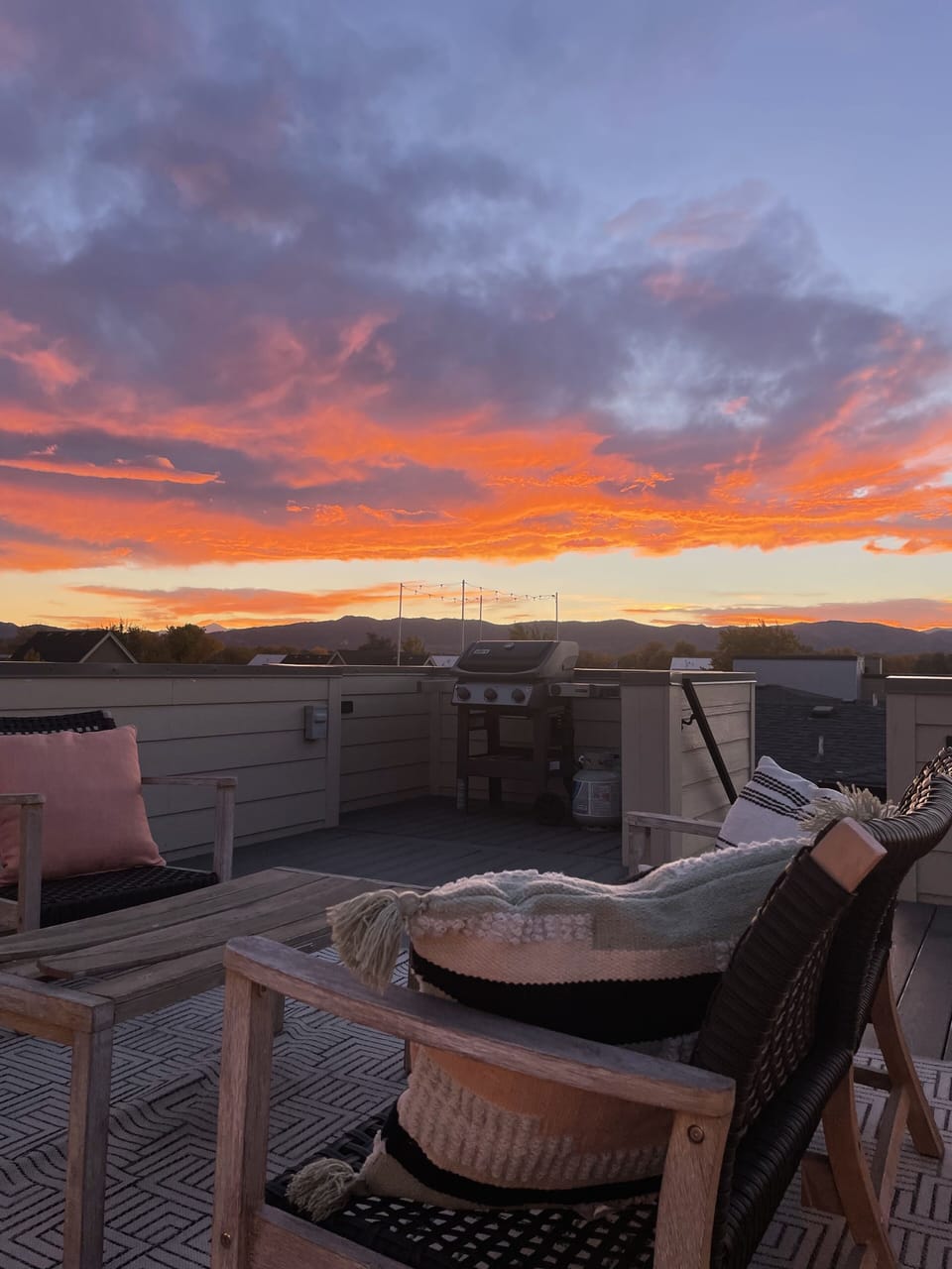 Private rooftop deck at sunset facing the mountains