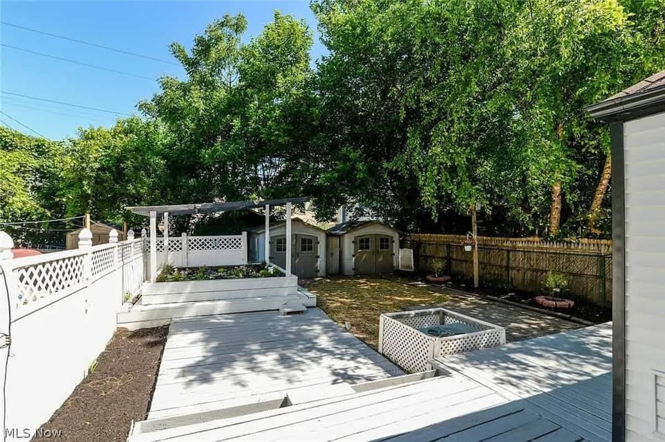 Backyard deck area w/ firepit & pergola, perfect for outdoor gatherings