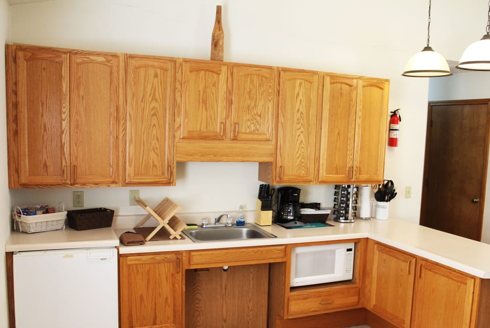 Cabin #1 @ Stone Creek - Kitchenette with fridge, sink, and other utensils.