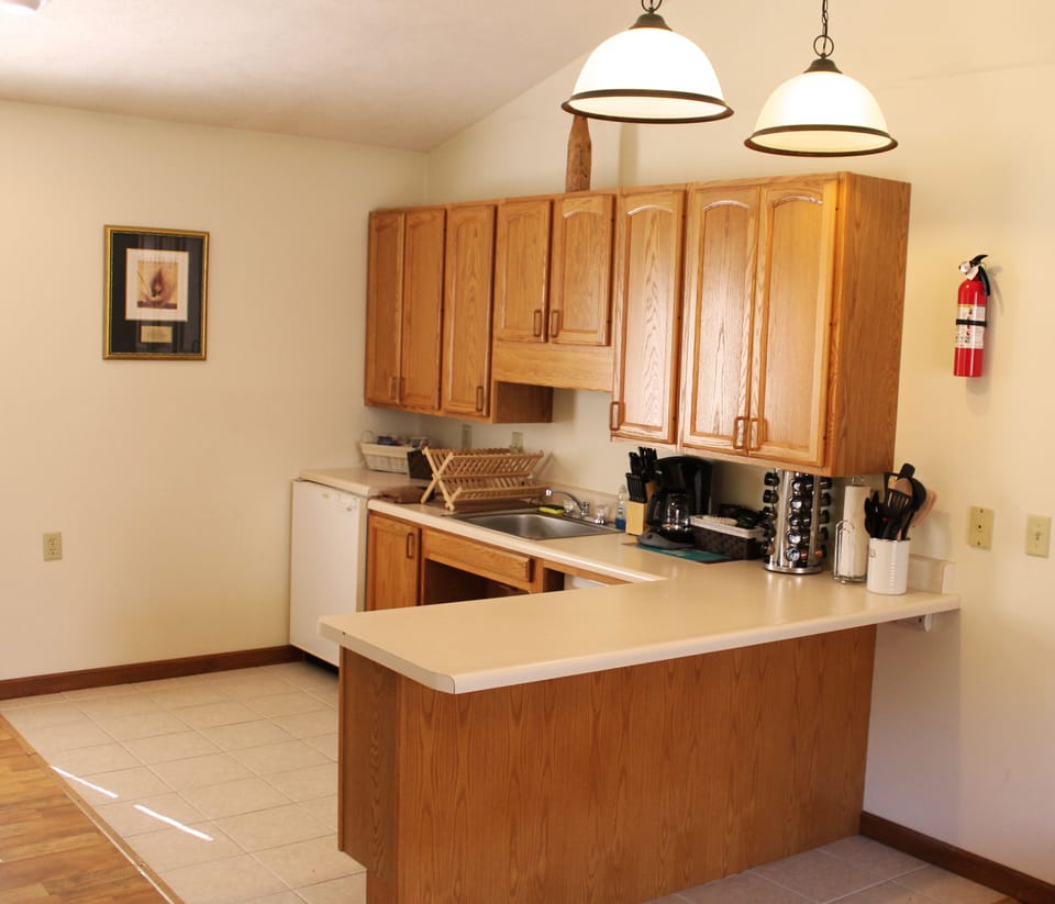Cabin #1 @ Stone Creek - Kitchenette with fridge, sink, and other utensils.
